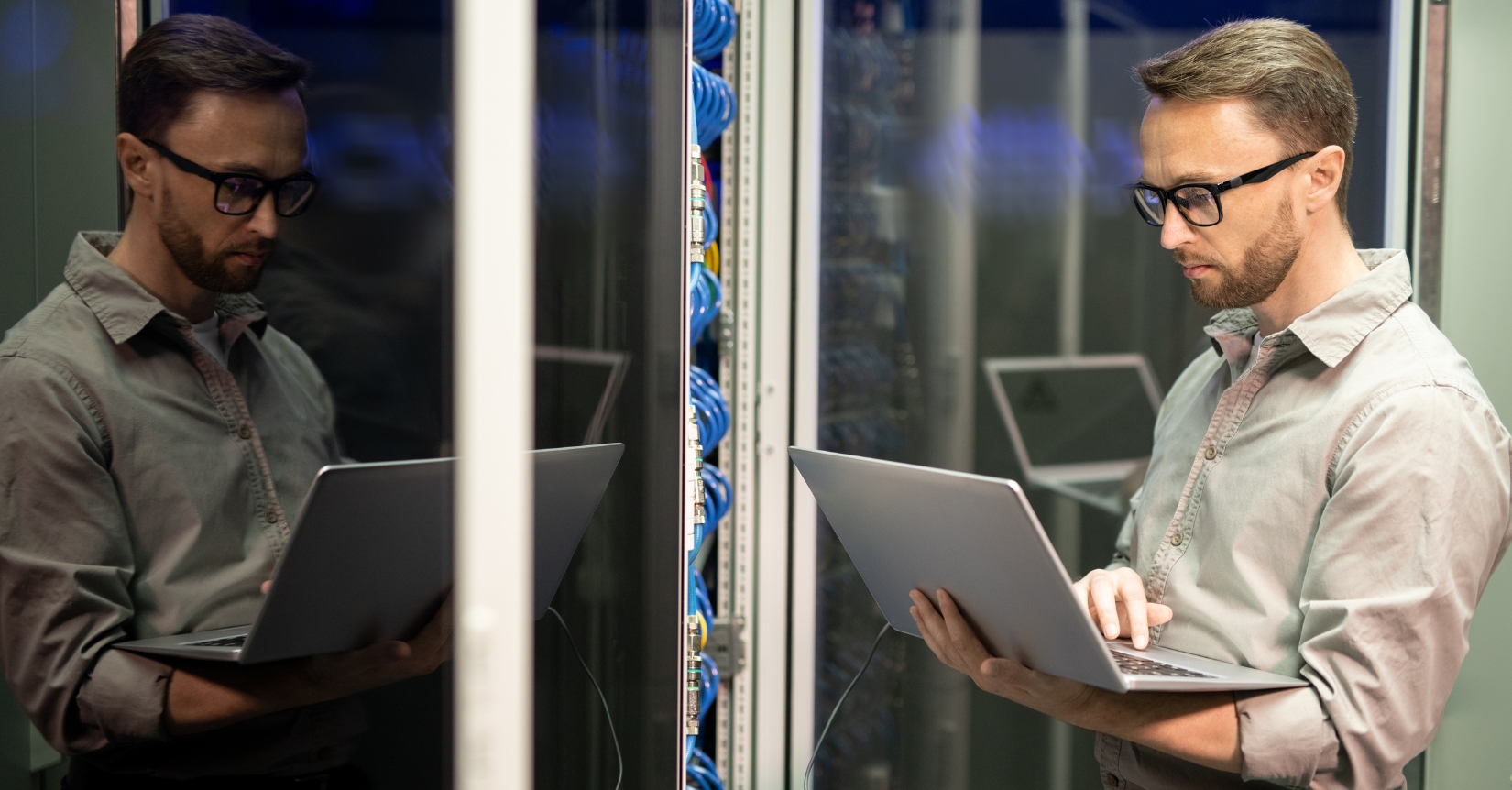 IT contractor working on a laptop in a server room
