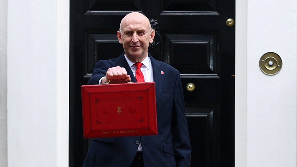 Chancellor John Healey with the red Budget suitcase outside 11 Downing Street.